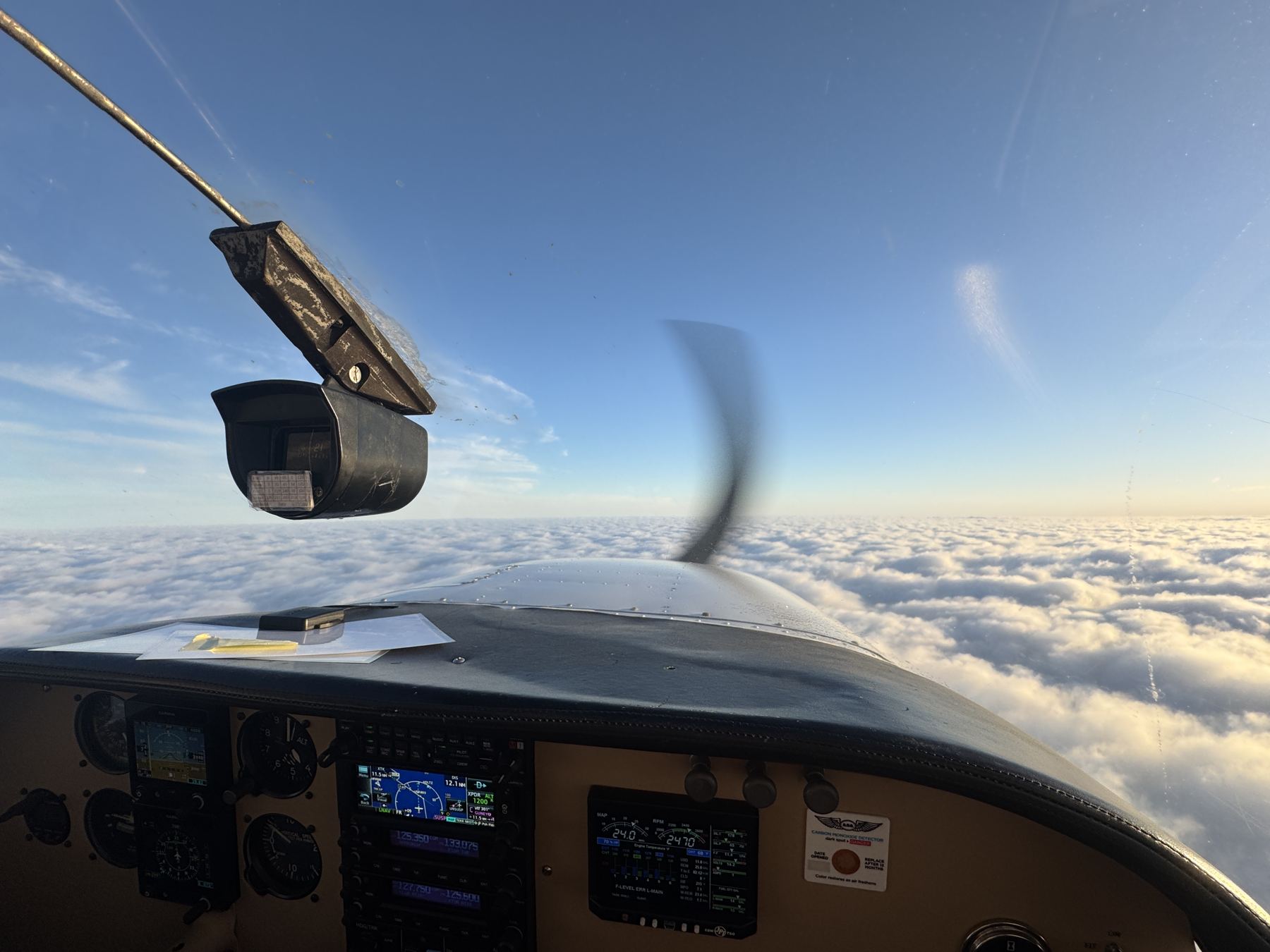 Above the clouds from the left seat of N8366X